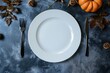 Autumn-Themed Table Setting with Pumpkins and Fall Leaves