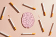 Smoking harms brain health. Tobacco or cigarettes with human brain organ symbol on brown background. Smoking increase risk for brain conditions, such as dementia, and stroke. World no tobacco day.