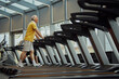 Cardio training to fat burning. Cheerful older adults, man and woman, make gym time enjoyable with humor. Concept of sport, active seniors in modern life, healthy lifestyle. Ad