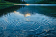 Gentle ripples on a crystal-clear lake, reflecting a sky at dawn for a calm and meditative background,
