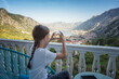 Rear view of little girl make heart shape with hands enjoying the view from the terrace of a room with a panoramic view of the picturesque Bay of Kotor in Montenegro