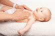 Caregiver Giving Chest Massage to Content Baby