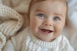 A closeup shot of a baby with a big, toothless smile and joyful eyes