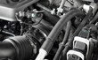 Car gasoline engine. Car engine part. Close-up image of an internal combustion engine. Engine details in a new car.