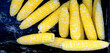 Fresh Clean Ears of Corn on the Cob in Bin at Market for Sale