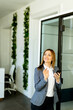 Professional woman engaging in a phone conversation in a modern office space