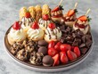 A plate of assorted desserts including chocolate and strawberry treats. The plate is placed on a countertop
