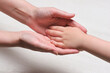 World mother day concept background. Mother and son hands close up.