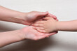 World mother day concept background. Mother and son hands close up.