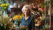 portrait of a happy adult woman who owns a flower shop, standing and smiling at the camera in front of her flower shop
