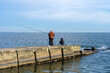 Fishermen on the pier catch fish