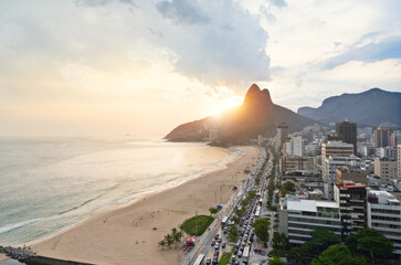 Wall Mural - Drone, beach and city with sunshine, nature and travel with Rio de Janeiro, Brazil and vacation. Getaway trip, aerial view and outdoor with mountains, seaside and sand with buildings and vacation