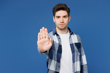 Wall Mural - Young sad serious Caucasian man he wear shirt white t-shirt casual clothes showing stop gesture with palm look camera isolated on plain blue cyan color background studio portrait. Lifestyle concept.