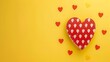   A yellow background bears a red heart with white polka dots, surrounded by red hearts