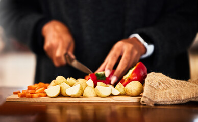 Wall Mural - Hands, vegetables and knife on board for prepare in home with raw ingredients with kitchen chef, food and health. Cooking, dinner and person for lunch with eating for nutrition with organic diet