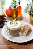 Fototapeta Tulipany - Mushroom soup. Bolete mushrooms cream with rosemary and garlic foam, served with toast with olive oil. 