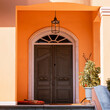 A classic design house entrance with an arched wooden door at posh suburbs of Athens. Travel in Greece.