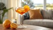   A glass of drink sits atop a wooden table, accompanied by a slice of orange on the same table