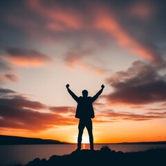 Poster - silhouette of a young man standing on the beach at sunset and raising his hand up, raised hands up. concept freedom hope,