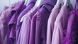 a rack adorned with clothes in various shades of purple against a pristine white background, inviting viewers into the world of style and sophistication.