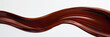 A wave of rich mahogany brown paint glides smoothly across the pristine white background