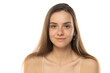 portrait of a young smiling teenage girl without makeup on a white background