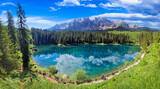 Fototapeta Most - Italy Idyllic nature scenery- trasparent mountain lake Carezza surrounded by Dolomites rocks- one of the most beautiful lakes of Alps. South Tyrol region.