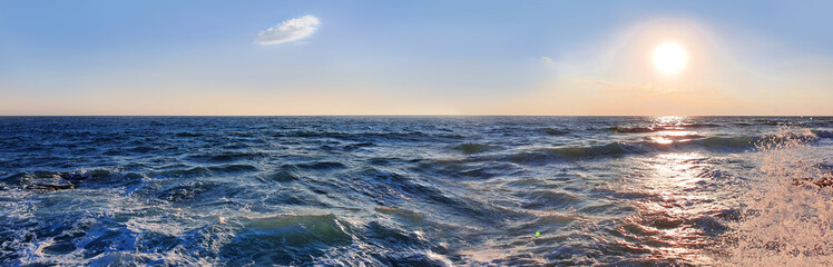 Wall Mural - colorful sunset with large sun under the sea waves.
