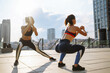 Two women have fitness day outdoors together. Warming up your muscles before an intense workout in the morning. Sport, Active life, sports training, healthy lifestyle.