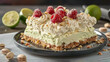   A plate with a slice of cake topped with whipped cream and raspberries, surrounded by nuts and lime slices