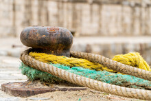 Old Mooring Bollard With Colorful Marine Ropes