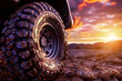 a close-up of a tire over the sunset backdrop.