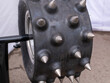 Heavy tractor tire with big metal spikes on it