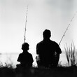 silhouette of a dad and son fishing
