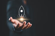 © Nirusmee - Startup business concept, Businessman holding rocket icon on virtual screen for fast start up business. Strategic planning and business success.