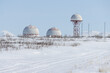 Aeronautical radar in the snowy tundra. Huge locators support aircraft flights. Large domes (radiotransparent shelters) of a radar station.