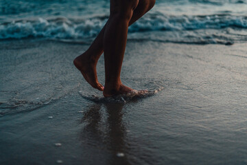 Wall Mural - Walking on the beach in the evening