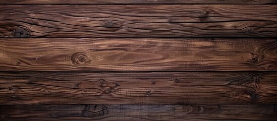 Wall Mural - Close up of a brown hardwood plank table with a blurred background