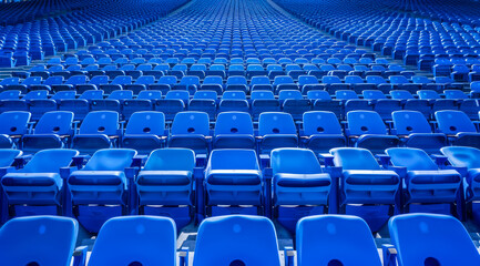 Big empty stadium full of blue seats