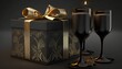 A black box with a gold ribbon and two black champagne glasses with gold rims are on a black table against a black background.

