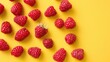Juicy red raspberries on a yellow background. Summer harvest, sweet snack.