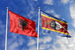 3d illustration. Albania and Eswatini Flag waving in sky. High detailed waving flag. 3D render. Waving in sky. Flags fluttered in the cloudy sky.