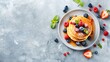 Breakfast composition with fresh pancakes and berries on light gray concrete background healthy food concept with copy space banner