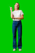 Young Woman Pointing Up Against Green Background