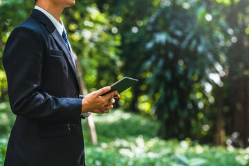 Business man using tablet to analyze ESG concept ,Sustainable development goal (SDGs) Ideas Globe Glass energy-based green business can limit climate change and global warming.