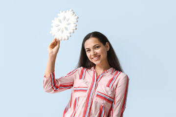 Canvas Print - Happy young woman with decorative snowflake on blue background