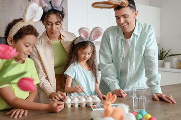 Sticker - Happy family painting eggs in kitchen on Easter Day