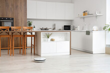 Interior Of Light Kitchen With Robot Vacuum Cleaner