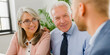 Senior couple man woman grey hair meeting financial adviser businessman for investment