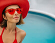portrait beauty blond woman in red bikini in swimming pool in summer lady with hat sunglasses red color